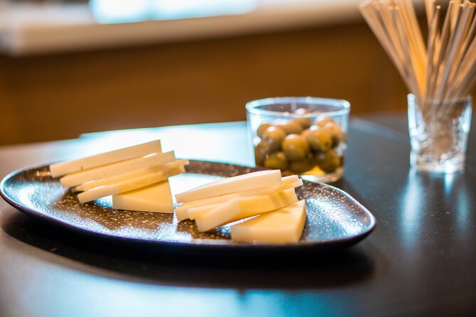 Pork Paradise: Iberian Gastronomy Tour - Stop 1 on C. Hernando Colón: sausages, cheese, bread, and sherry