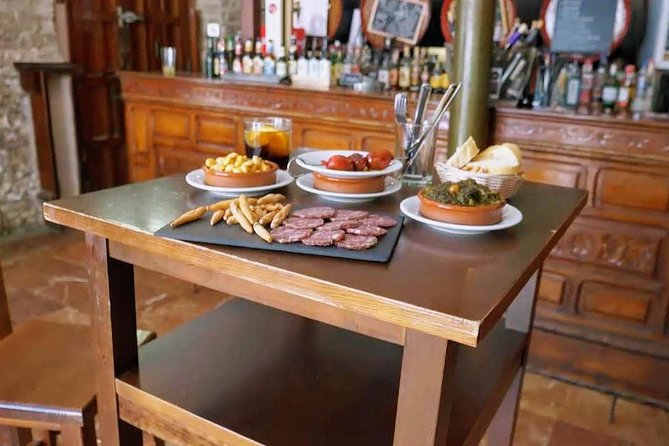 Sevilla Food Tour: Tapas, Wine, History & Traditions - Barrio Santa Cruz: albóndigas, pestiños, and PX in a patio setting
