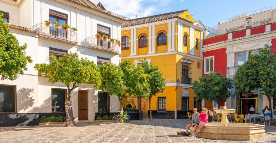 Seville: Barrio de Santa Cruz Small Group Walking Tour - Finding the meeting point at Plaza del Triunfo (that orange umbrella helps)